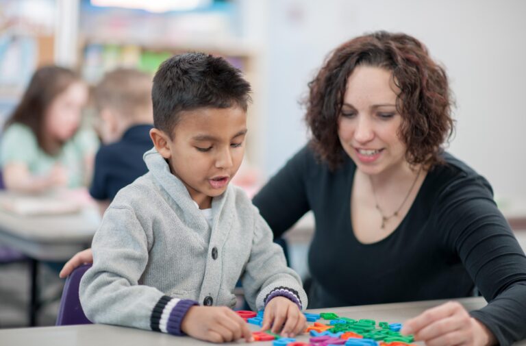 teacher helping out a student